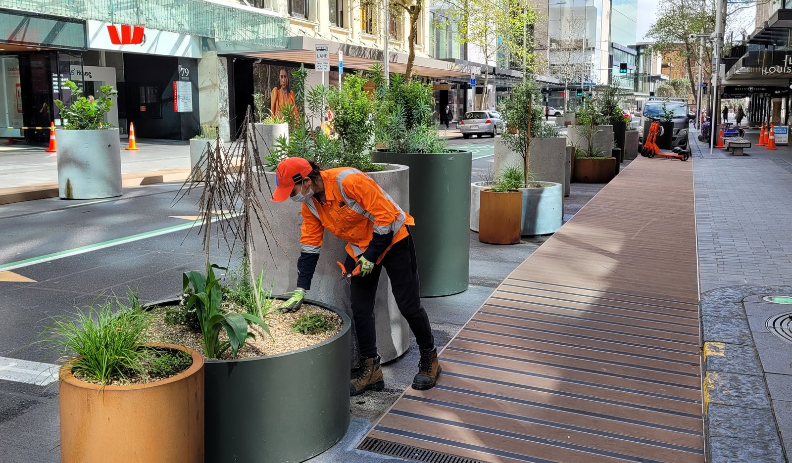 Evergreen Landcare operator maintaining street planters in a town centre streetscape